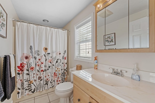 bathroom featuring toilet, a shower with shower curtain, vanity, and tile patterned floors