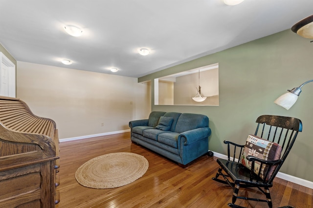 living area with wood finished floors and baseboards