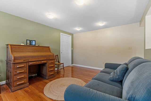 living room with baseboards and wood finished floors