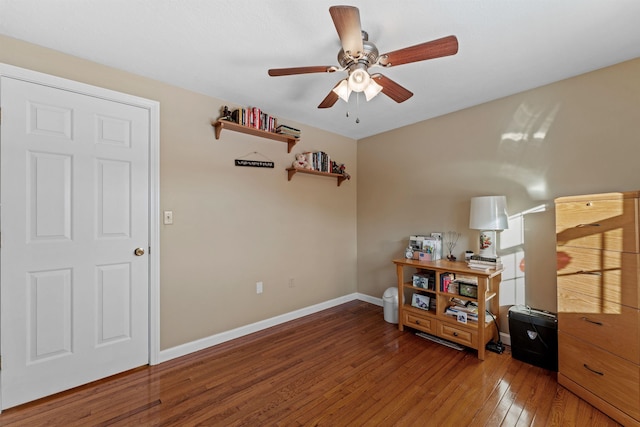 interior space with light wood-type flooring, a ceiling fan, and baseboards