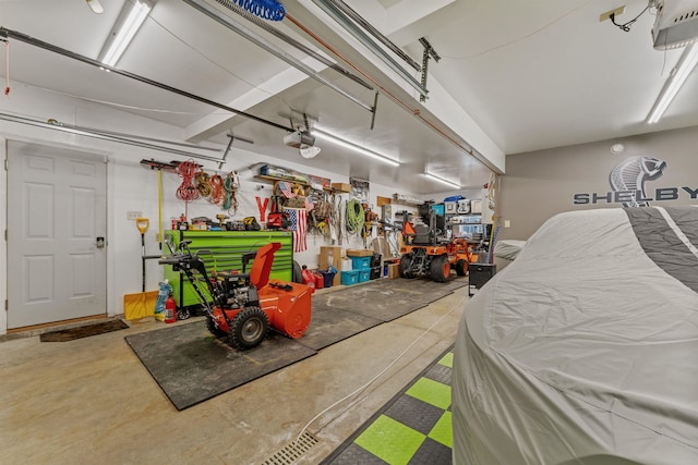 garage with a workshop area and a garage door opener