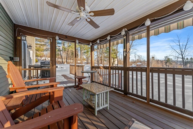 sunroom / solarium featuring a ceiling fan and a wealth of natural light