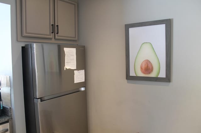 interior details with gray cabinets and freestanding refrigerator