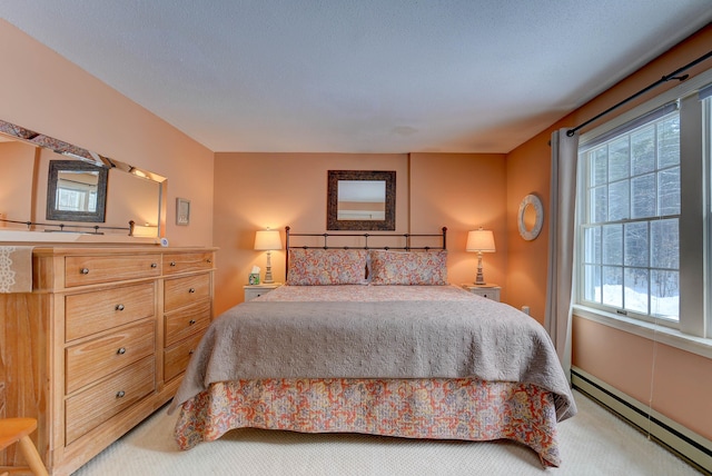 bedroom with a textured ceiling, a baseboard radiator, and carpet flooring