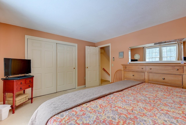 bedroom featuring light carpet and a closet