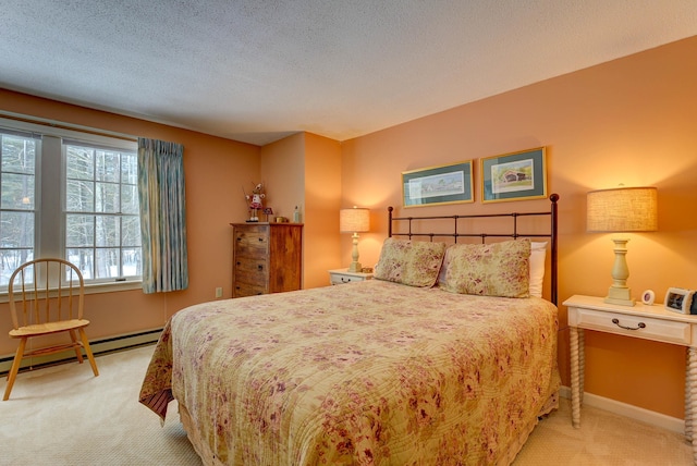 carpeted bedroom featuring a baseboard heating unit, a textured ceiling, and baseboards