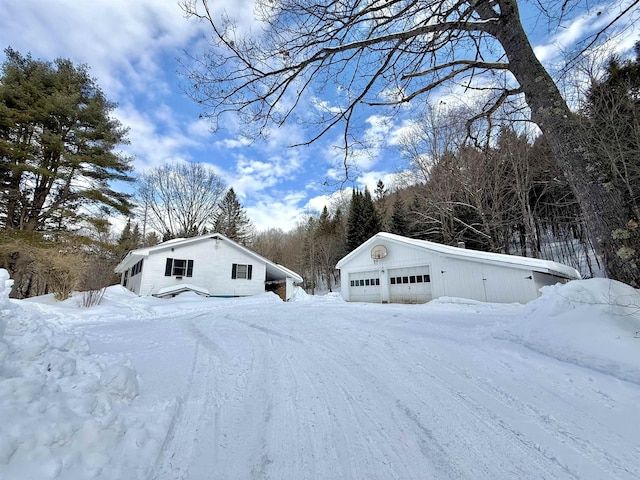 exterior space with a garage and an outdoor structure