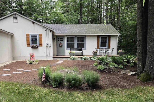 view of front of property with covered porch and roof with shingles