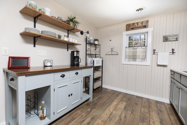 kitchen with baseboards, visible vents, wood counters, dark wood-type flooring, and open shelves