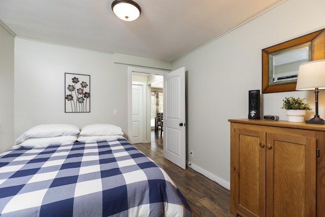 bedroom featuring crown molding, baseboards, and dark wood-style flooring