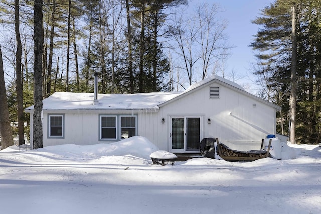 view of snow covered rear of property