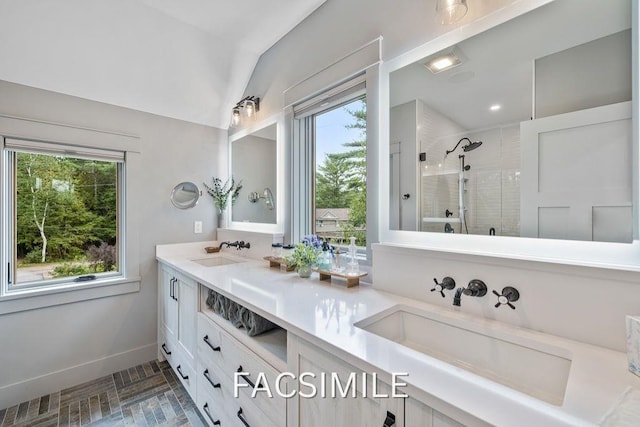 bathroom with a stall shower, a sink, and a wealth of natural light