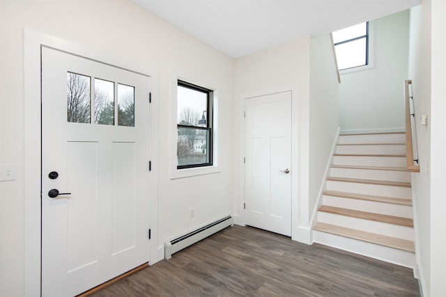 entryway with dark wood-style floors, stairs, and a baseboard heating unit