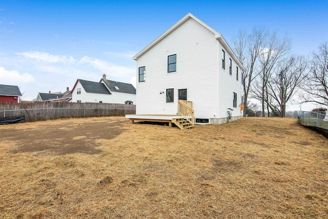 back of house featuring fence private yard and a yard