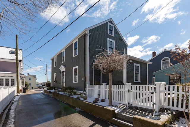 exterior space with a fenced front yard and a gate