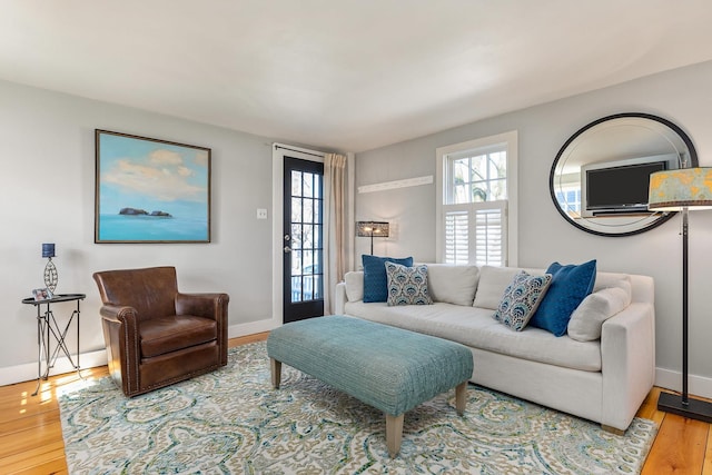 living room featuring baseboards and wood finished floors