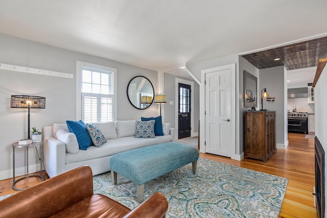 living room featuring light wood-type flooring and baseboards