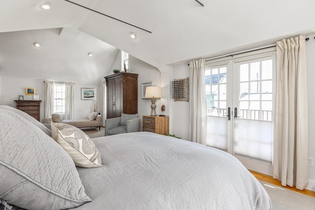 bedroom with lofted ceiling, light wood finished floors, recessed lighting, and french doors