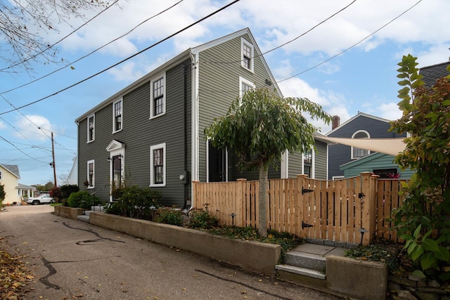 view of side of home featuring a fenced front yard