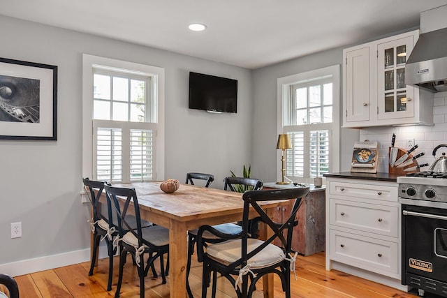 dining area featuring light wood-type flooring and baseboards