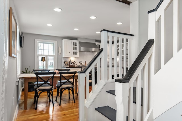 interior space featuring light wood finished floors, stairway, and recessed lighting