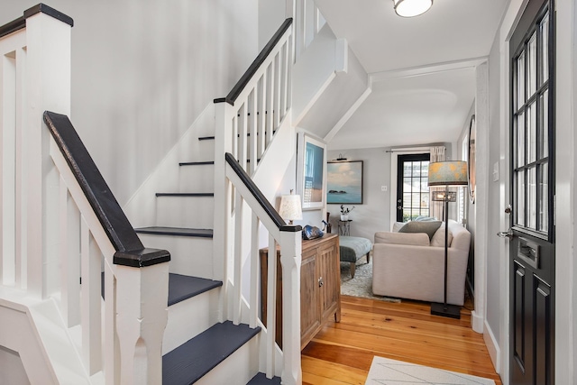 staircase with hardwood / wood-style floors