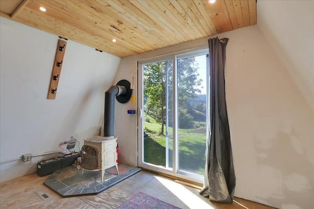 interior details featuring a wood stove, wood ceiling, and recessed lighting