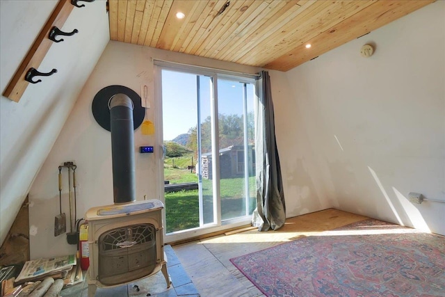 interior space featuring a wood stove, wood ceiling, vaulted ceiling, and recessed lighting