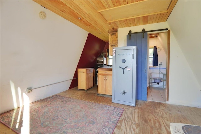 kitchen featuring wood finished floors, wood ceiling, and light brown cabinetry