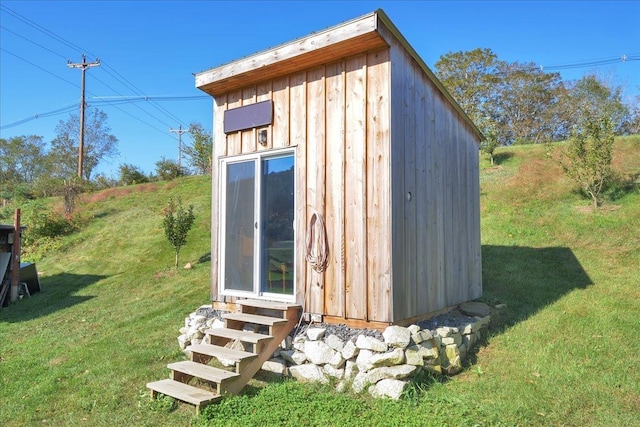 view of outdoor structure with entry steps and an outbuilding