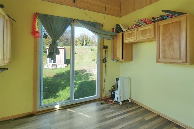 interior space with baseboards and wood finished floors