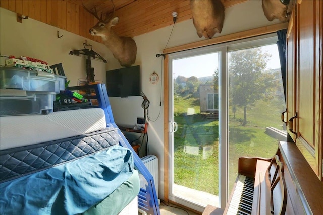 bedroom featuring lofted ceiling and wooden ceiling