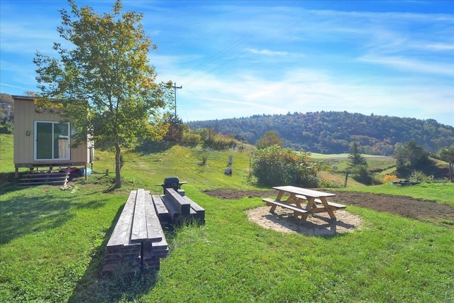 surrounding community featuring a lawn and an outdoor structure