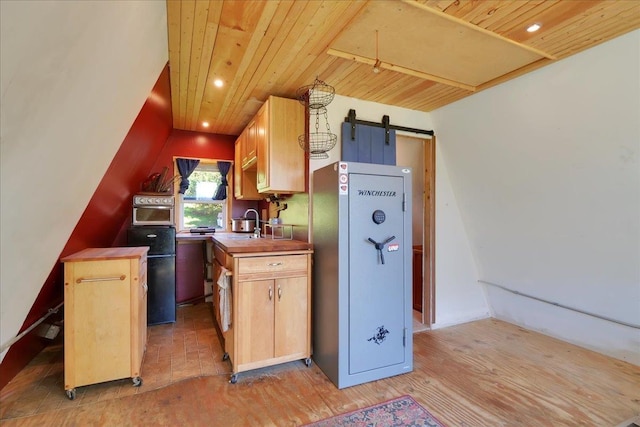 kitchen with light wood finished floors, a barn door, wood ceiling, butcher block countertops, and recessed lighting