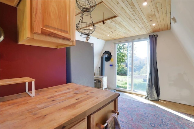 dining room featuring vaulted ceiling, a wood stove, wood ceiling, and recessed lighting