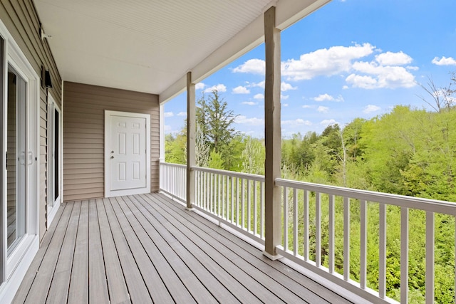 wooden deck with a wooded view