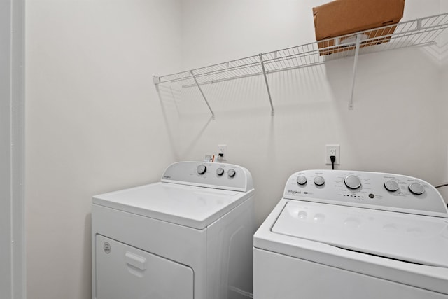 clothes washing area with laundry area and washer and dryer