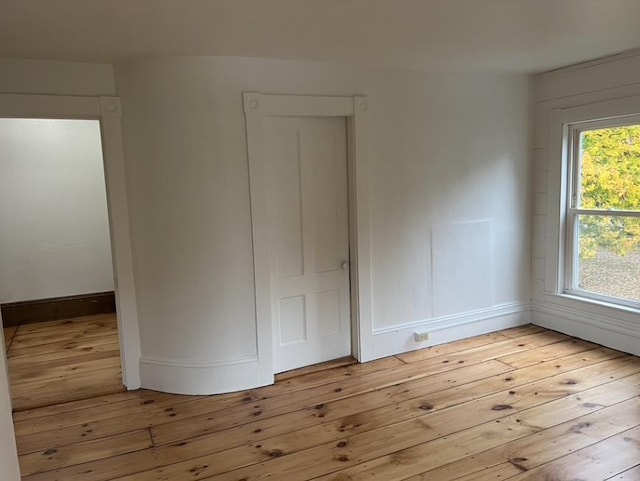 unfurnished bedroom with light wood-style floors