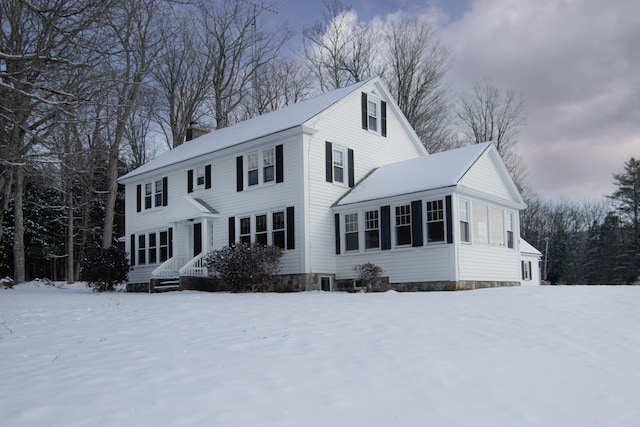 view of front facade with a chimney