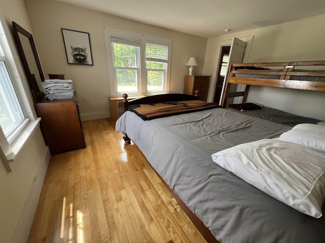 bedroom with baseboards and light wood finished floors