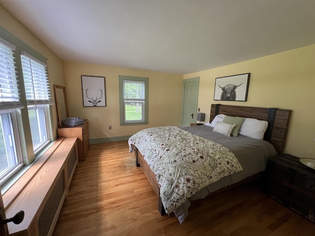 bedroom with light wood-style floors and baseboards