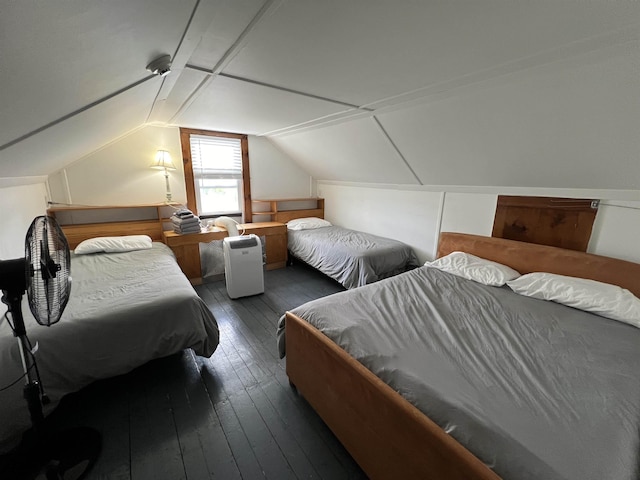 bedroom featuring vaulted ceiling and wood-type flooring