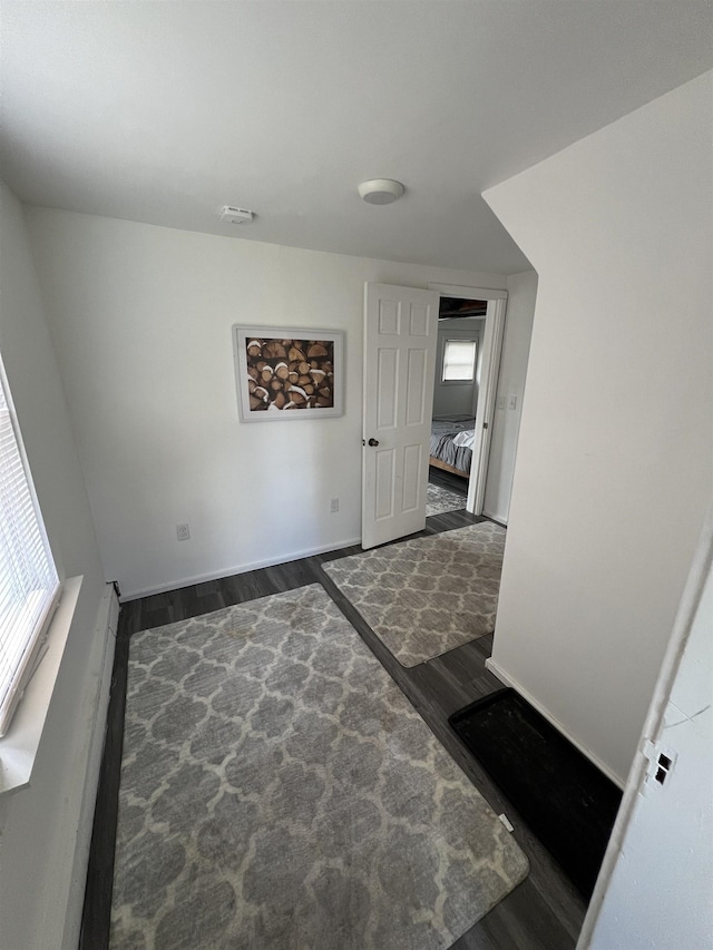 interior space featuring wood finished floors and baseboards