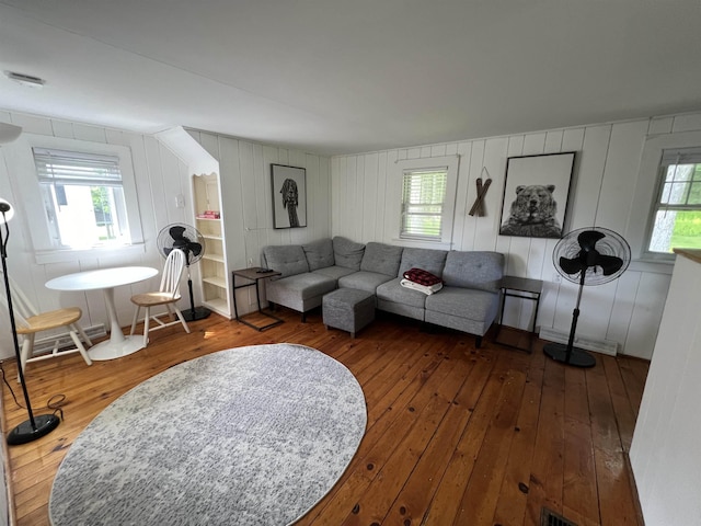 living room with wood-type flooring and a healthy amount of sunlight