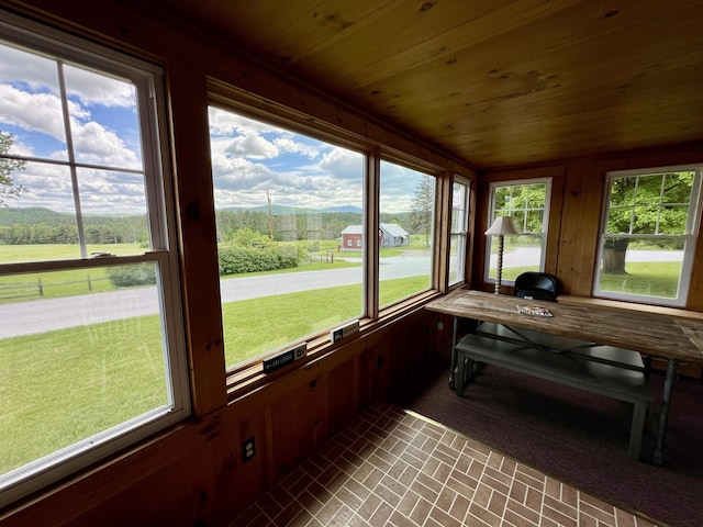 sunroom featuring wood ceiling