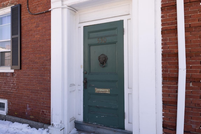 entrance to property with brick siding