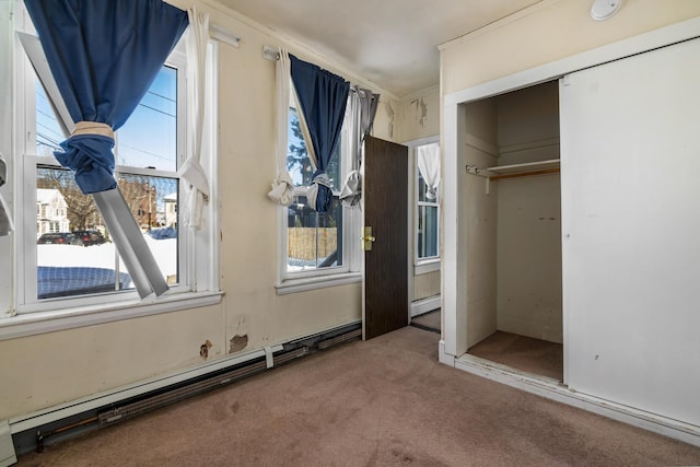 interior space featuring a baseboard heating unit, carpet, a closet, and baseboard heating