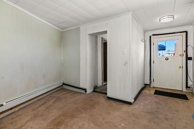 carpeted empty room with a baseboard radiator and crown molding