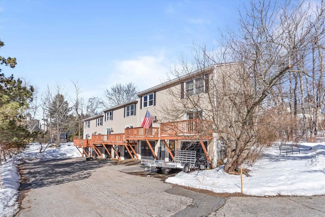 view of front of property with stairway and a wooden deck