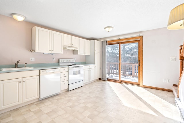 kitchen with white appliances, light floors, light countertops, under cabinet range hood, and a sink